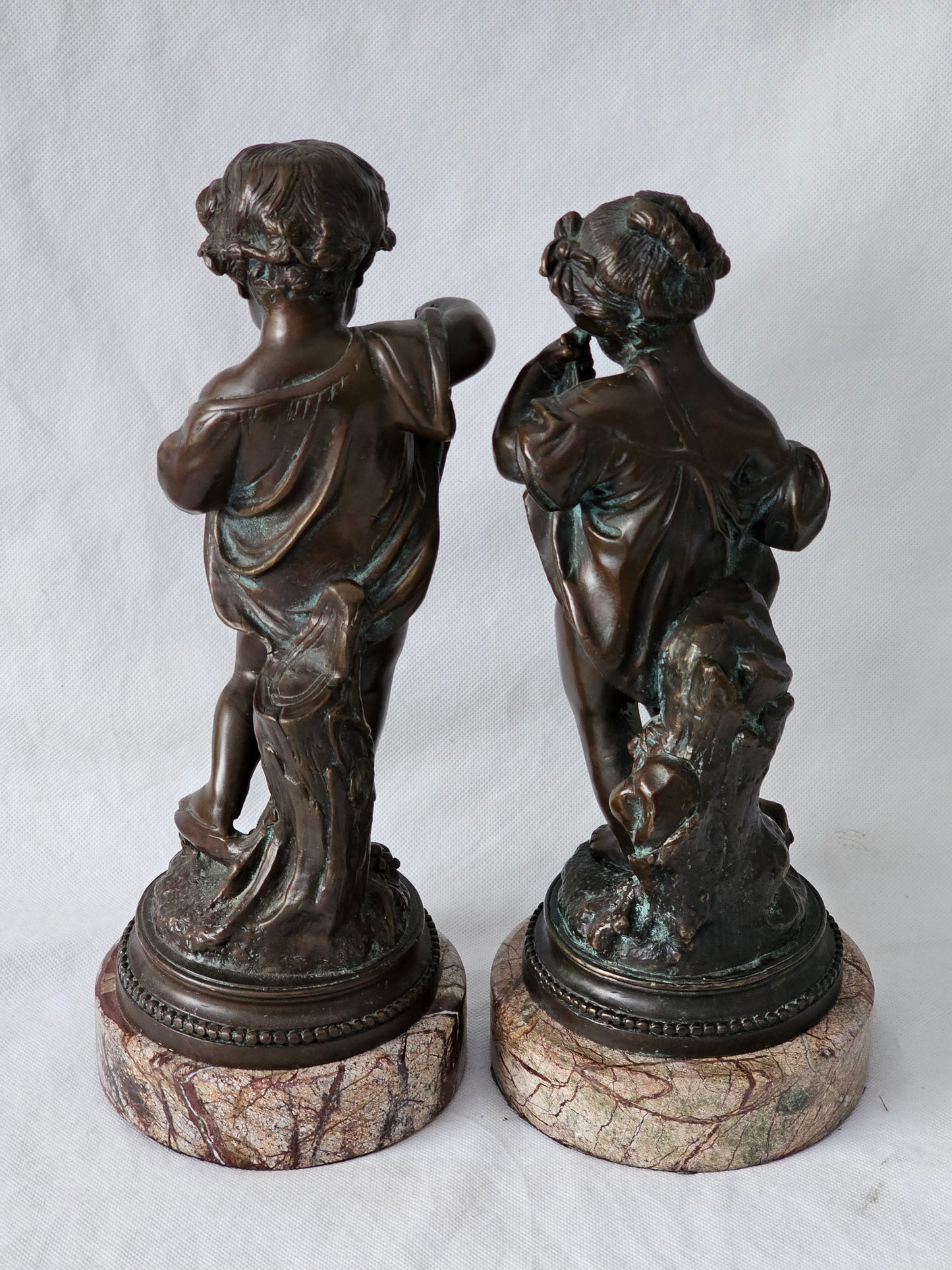 An Antique Pair of Bronze Patinaed Putti Cherubs on Marble Plinths,