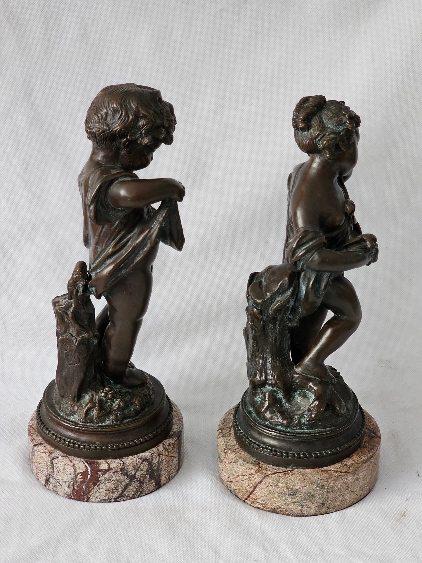 An Antique Pair of Bronze Patinaed Putti Cherubs on Marble Plinths,