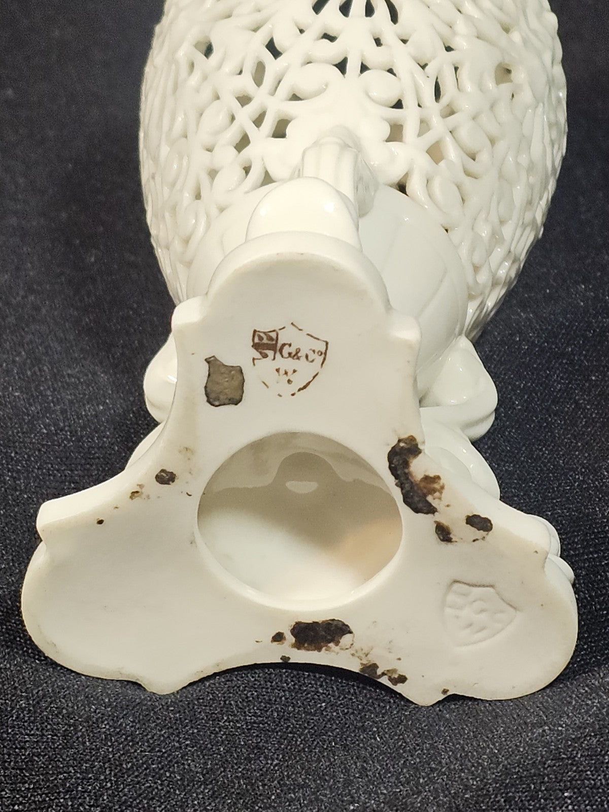 An Antique White Porcelain Grainger Vase Reticulated with Faces on 3 Fish Feet