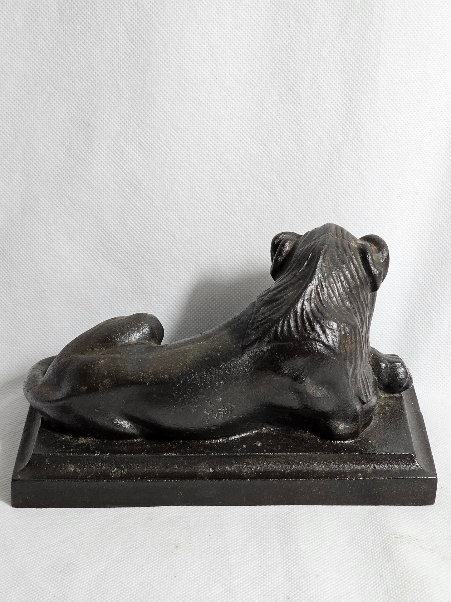 A Cast Iron Sculpture of a Recumbent Lion, on a Rectangular Base,