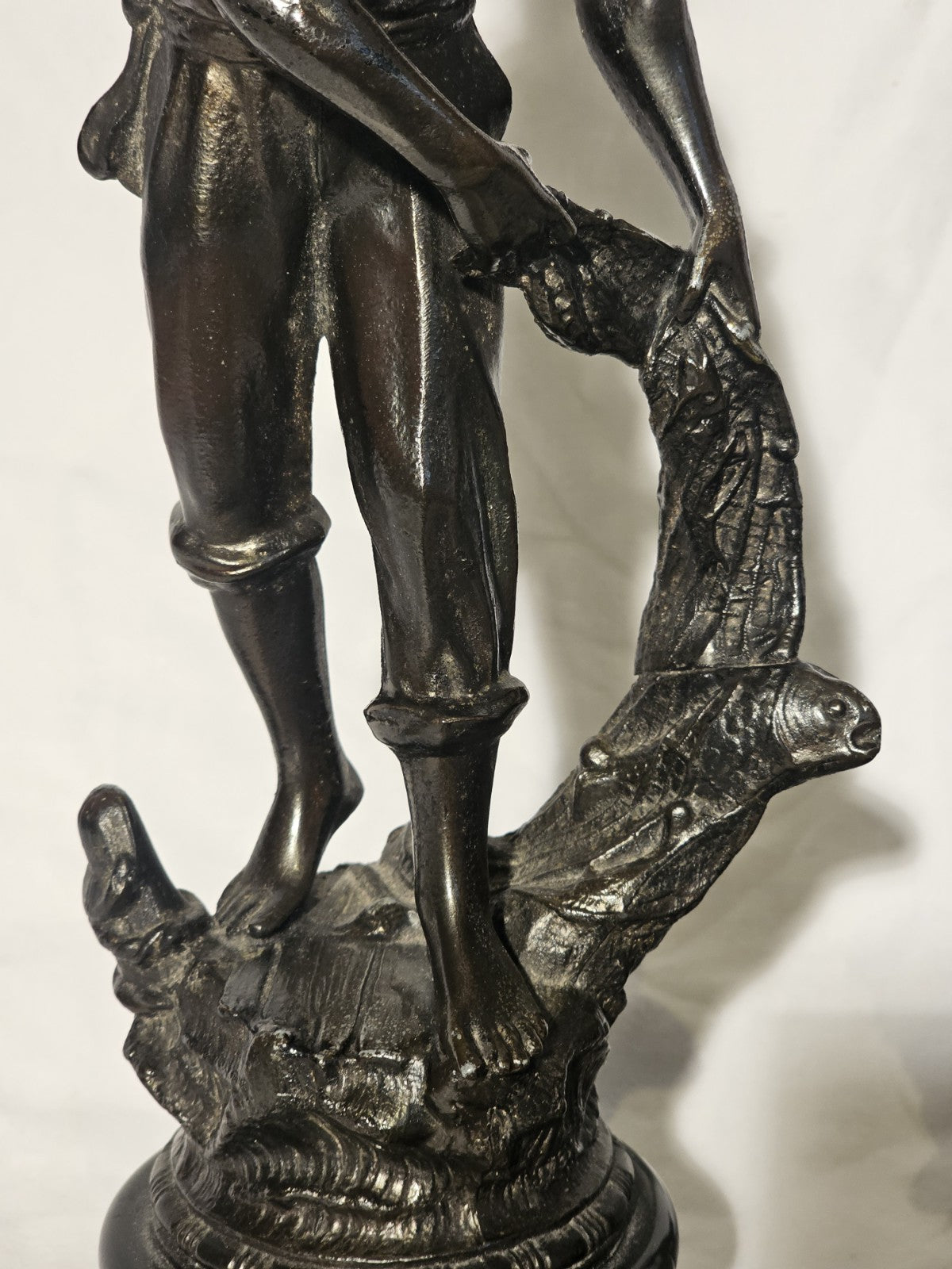 An Antique Pair of Bronzed Spelter Figures of a Fisherman and Woman,