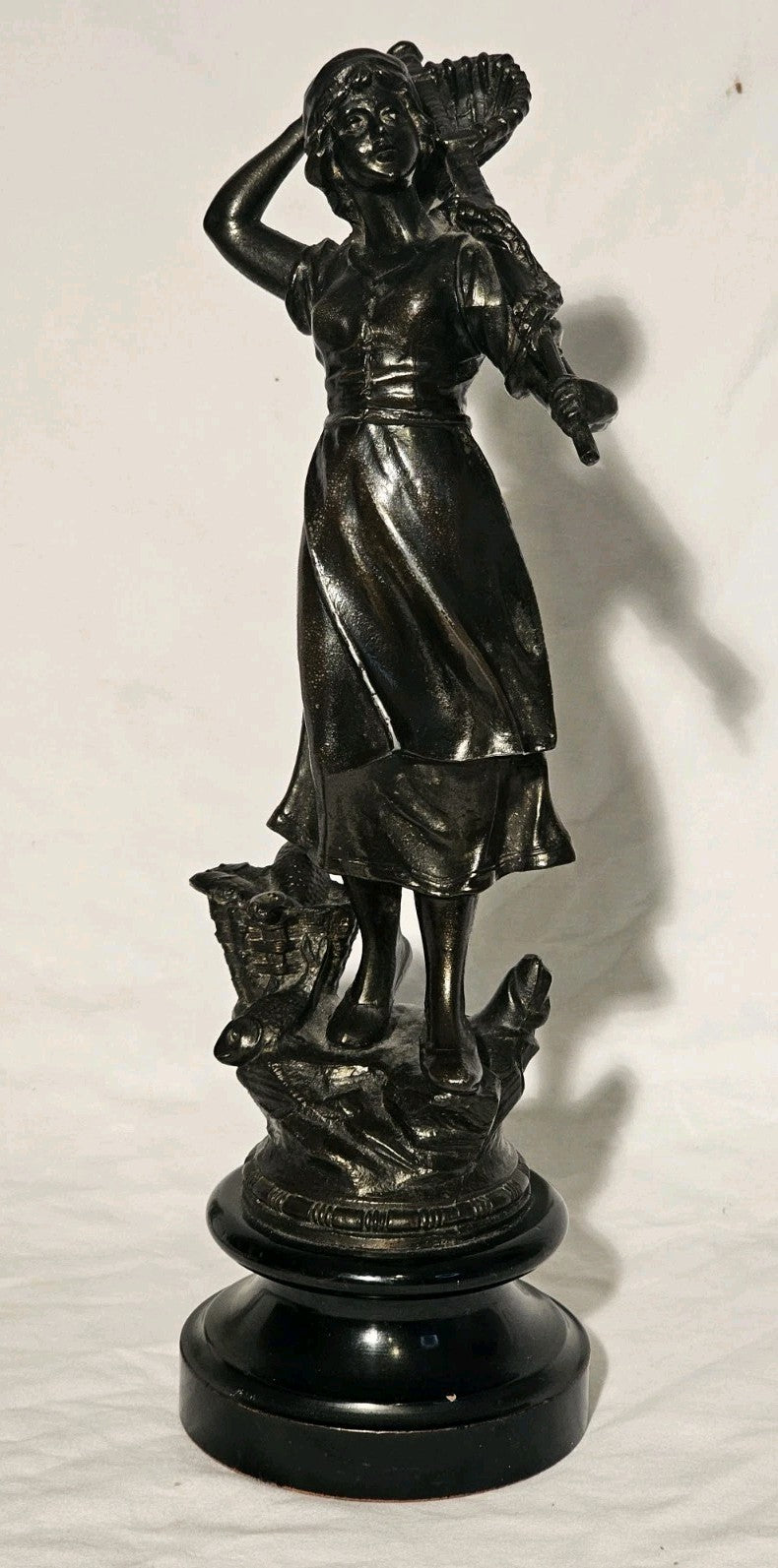 An Antique Pair of Bronzed Spelter Figures of a Fisherman and Woman,