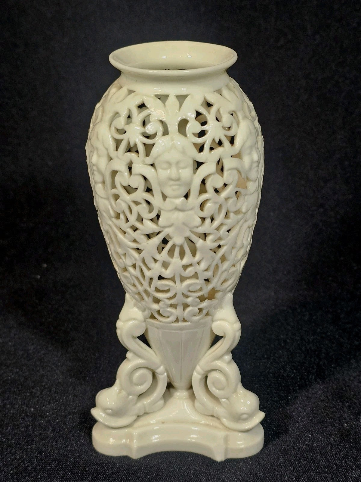 An Antique White Porcelain Grainger Vase Reticulated with Faces on 3 Fish Feet
