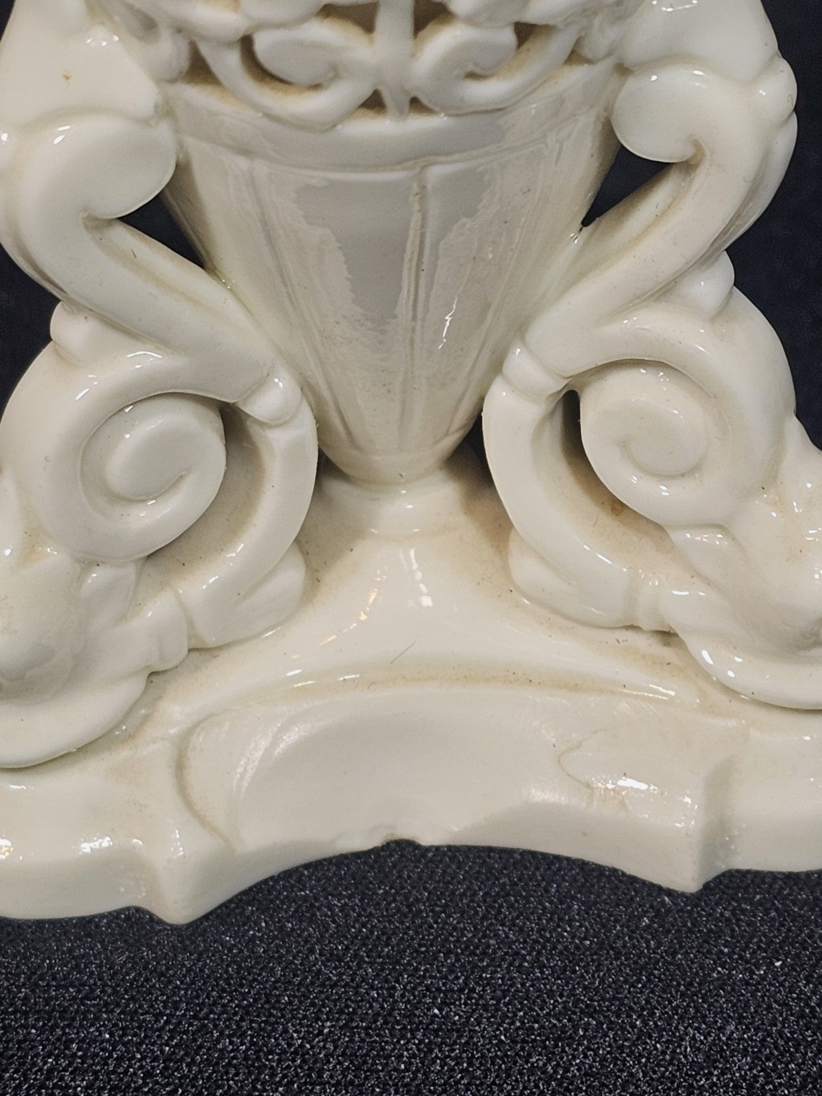An Antique White Porcelain Grainger Vase Reticulated with Faces on 3 Fish Feet