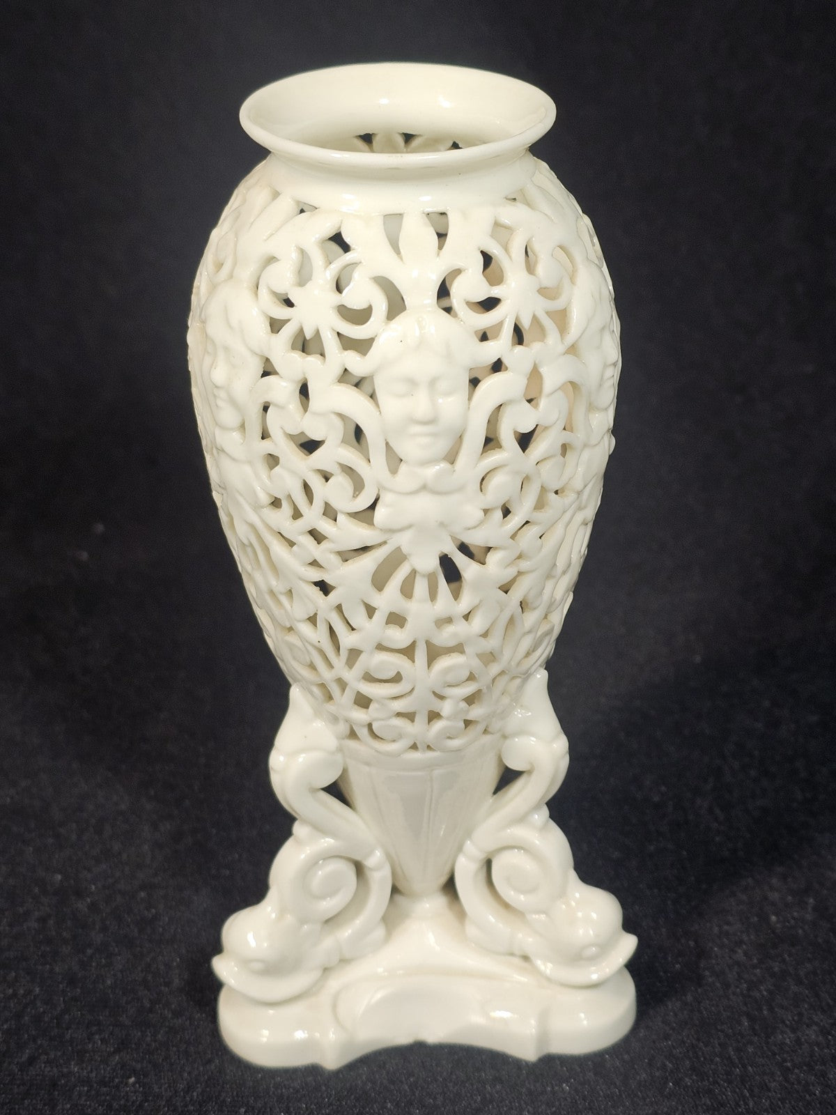 An Antique White Porcelain Grainger Vase Reticulated with Faces on 3 Fish Feet