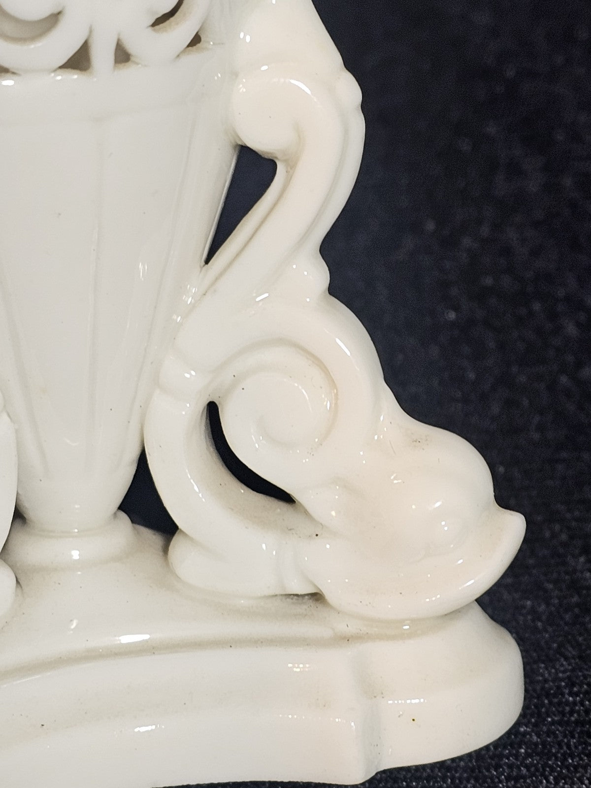 An Antique White Porcelain Grainger Vase Reticulated with Faces on 3 Fish Feet