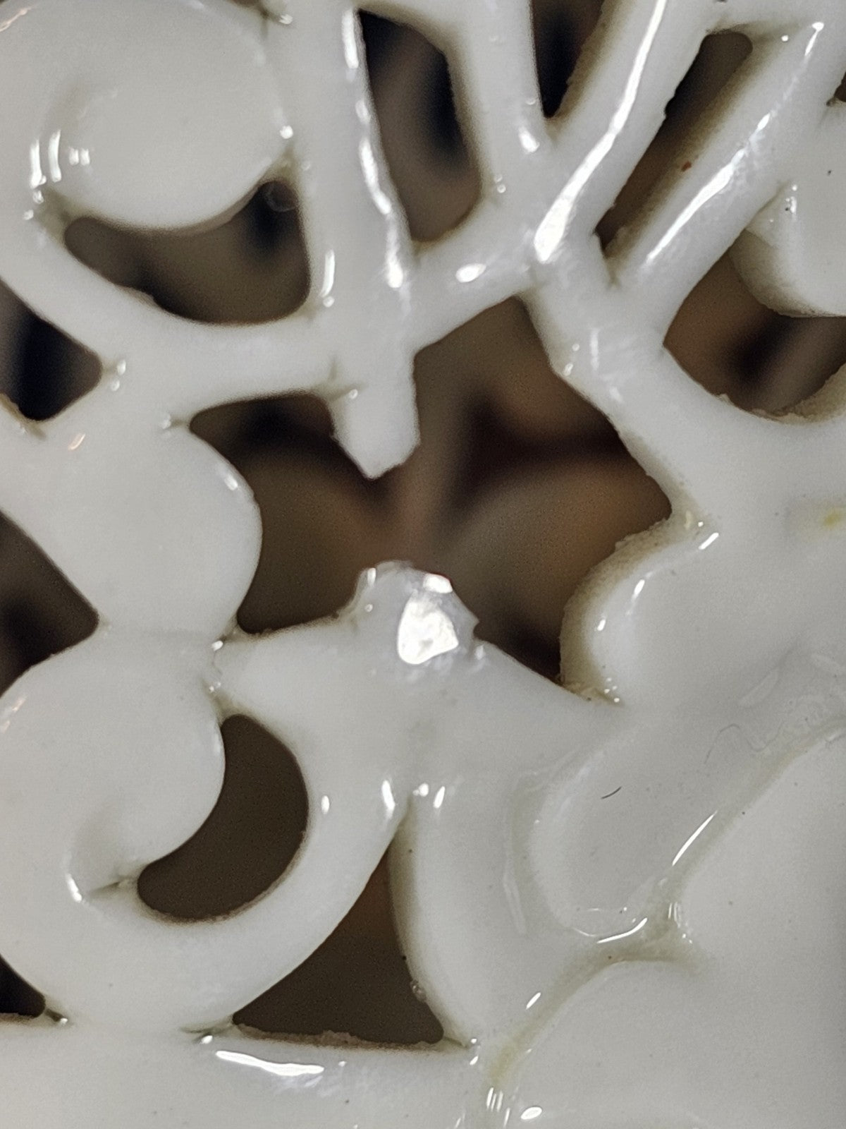 An Antique White Porcelain Grainger Vase Reticulated with Faces on 3 Fish Feet