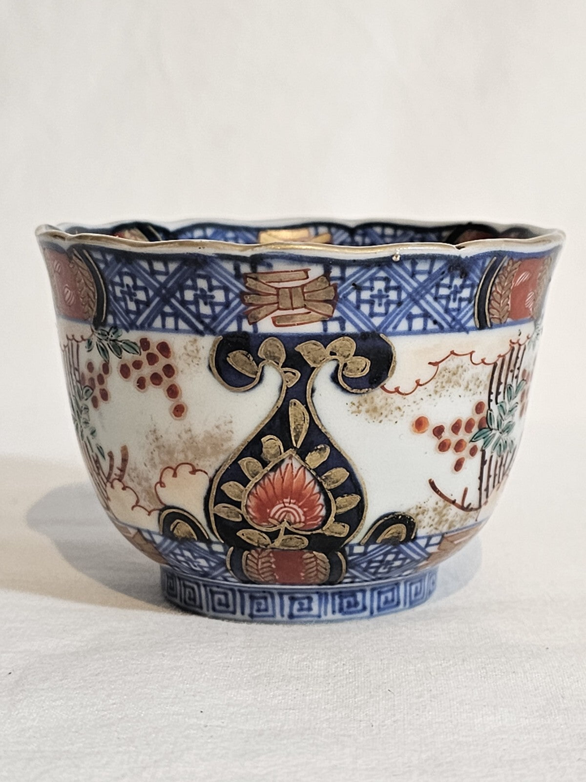 A 19thC Japanese Porcelain Tea Bowl Painted with Stylised Flowers, a Dragon
