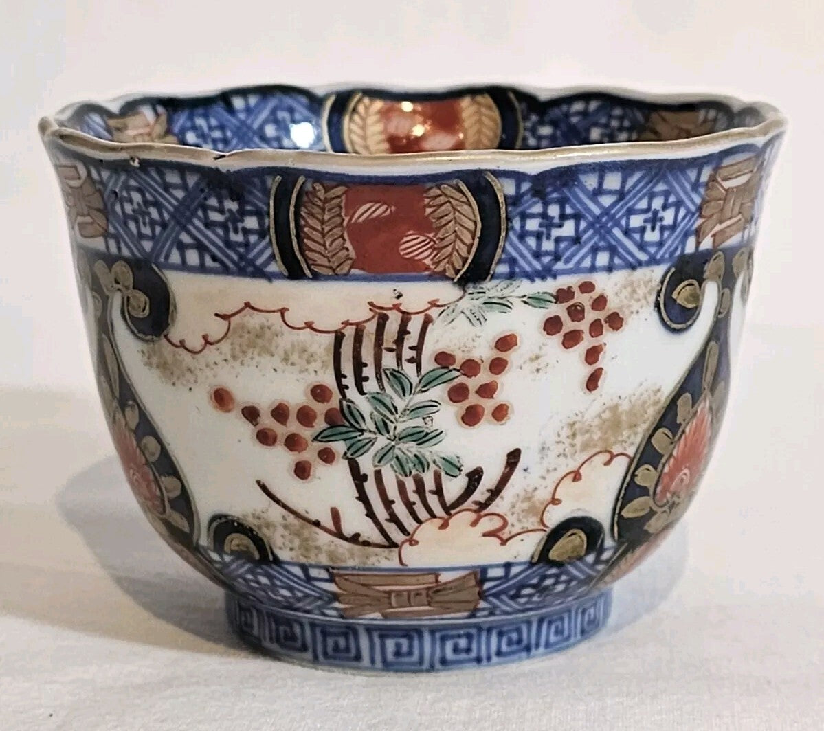 A 19thC Japanese Porcelain Tea Bowl Painted with Stylised Flowers, a Dragon