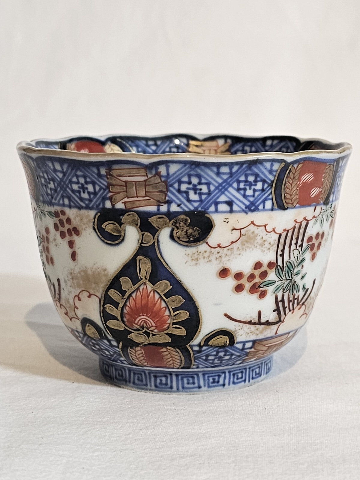 A 19thC Japanese Porcelain Tea Bowl Painted with Stylised Flowers, a Dragon