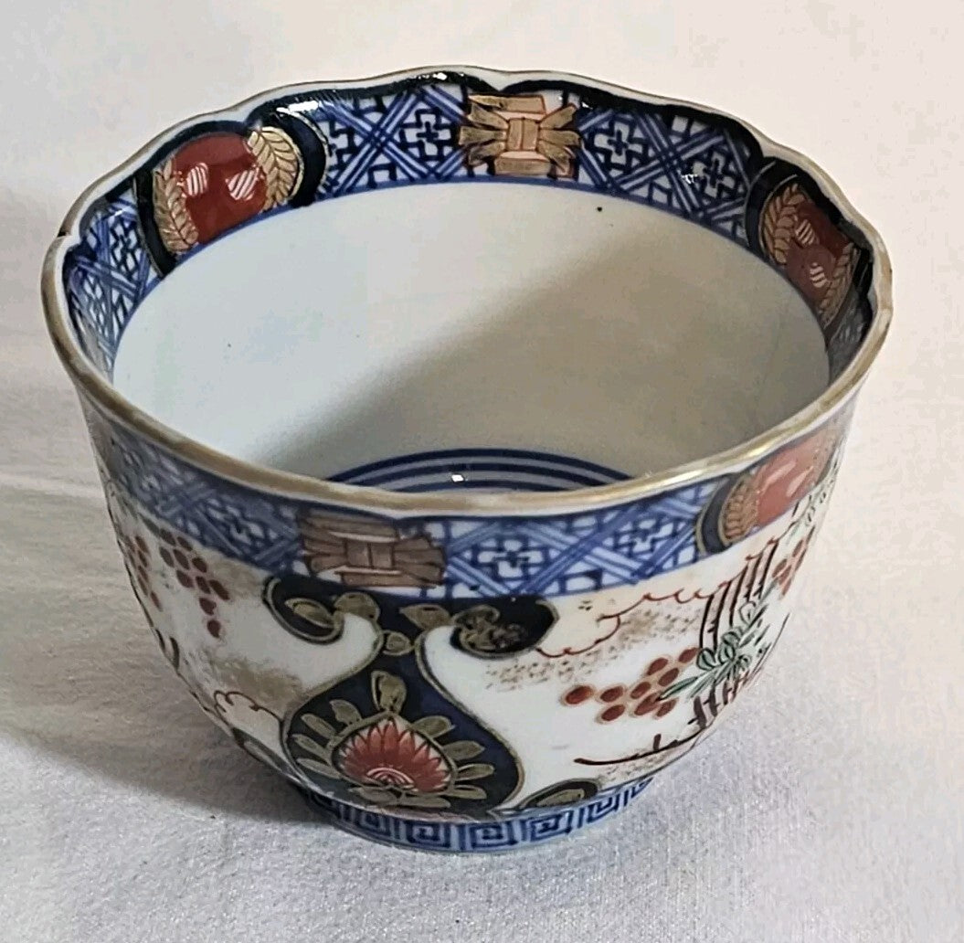 A 19thC Japanese Porcelain Tea Bowl Painted with Stylised Flowers, a Dragon