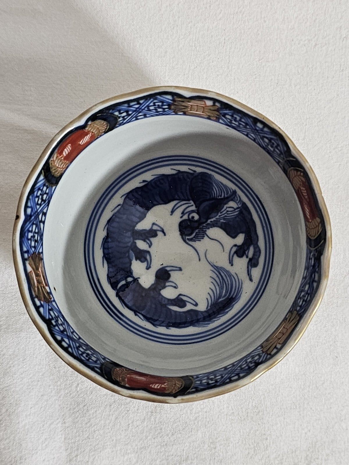 A 19thC Japanese Porcelain Tea Bowl Painted with Stylised Flowers, a Dragon