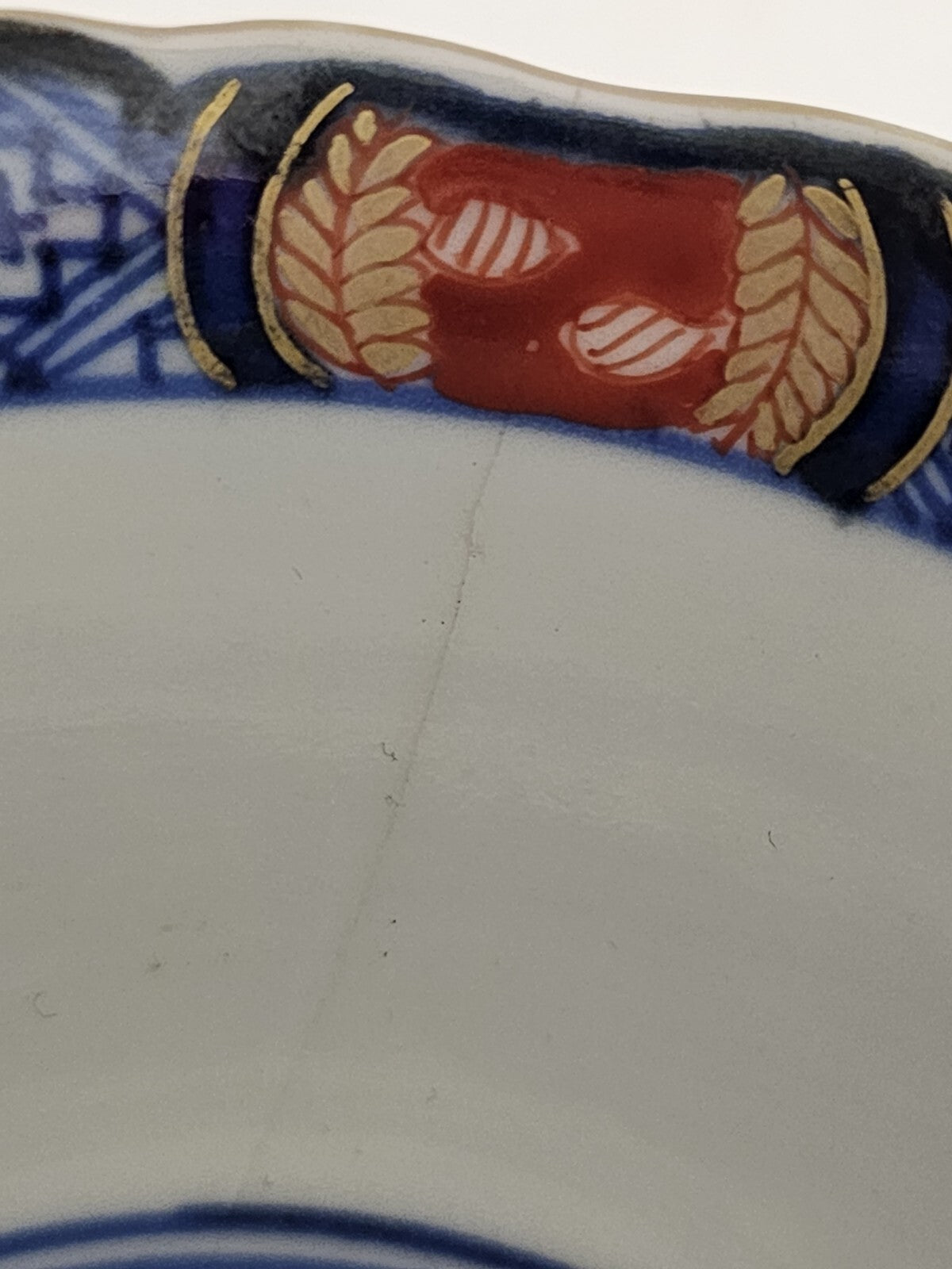 A 19thC Japanese Porcelain Tea Bowl Painted with Stylised Flowers, a Dragon