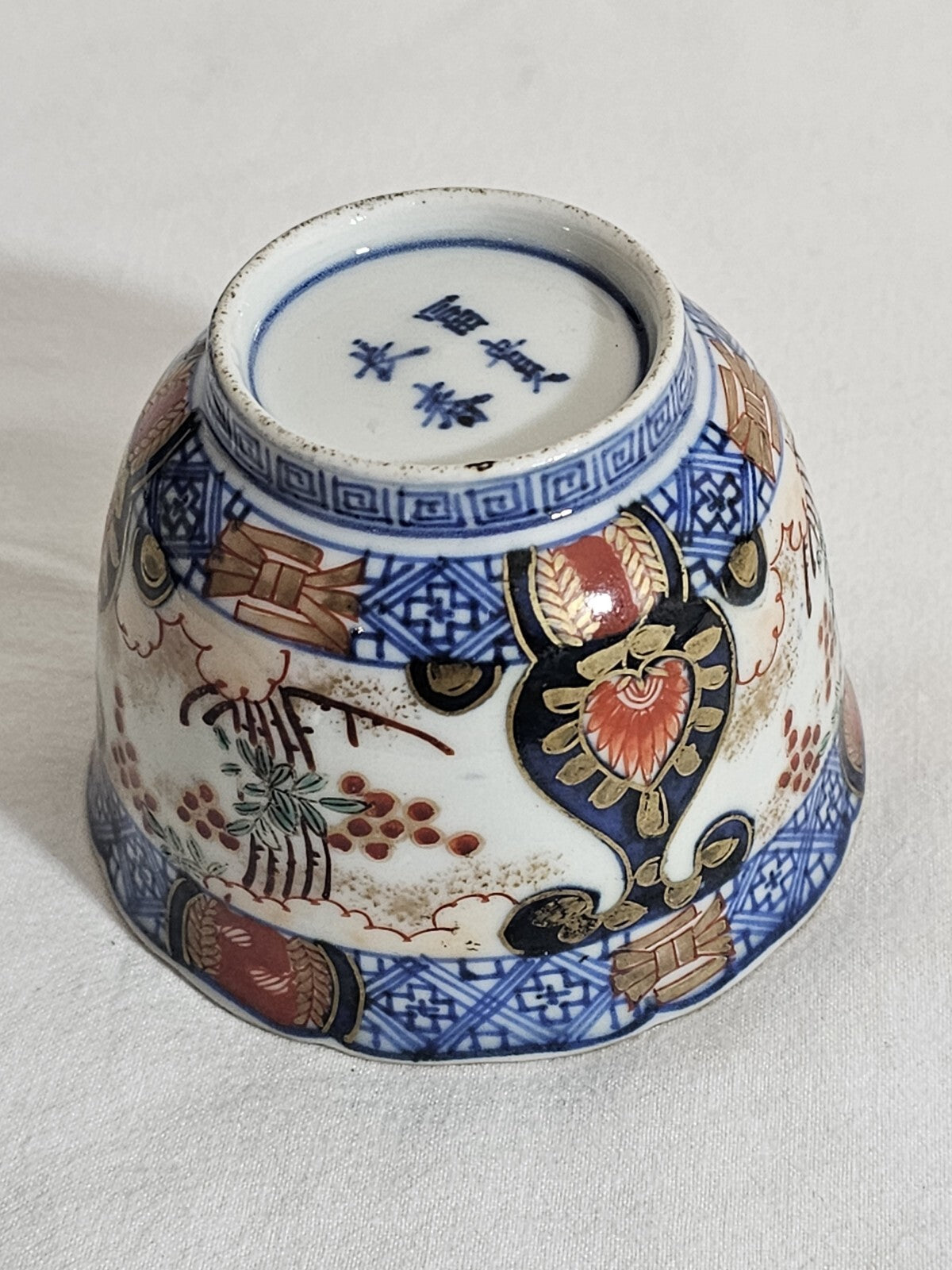 A 19thC Japanese Porcelain Tea Bowl Painted with Stylised Flowers, a Dragon