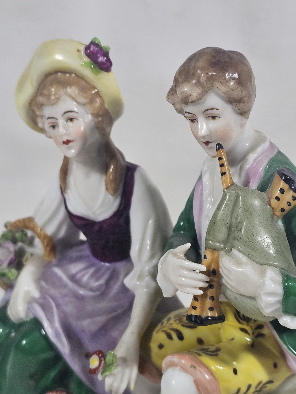 A Victorian German Porcelain Figure Group of a Couple Seated, Hand Painted