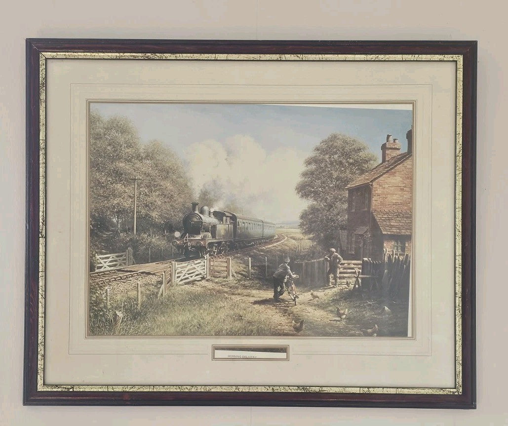 A Vintage Framed Print of a Train and Village Titled - Morning Delivery