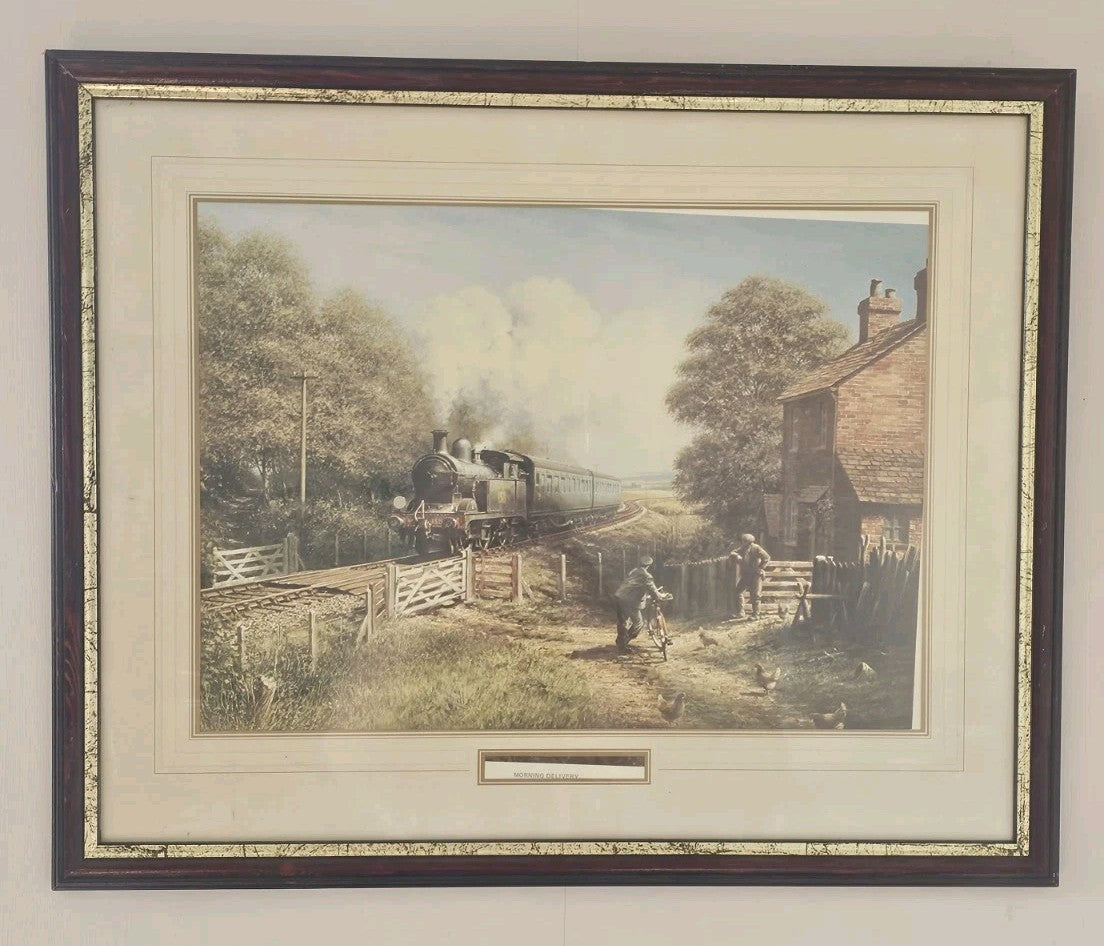 A Vintage Framed Print of a Train and Village Titled - Morning Delivery