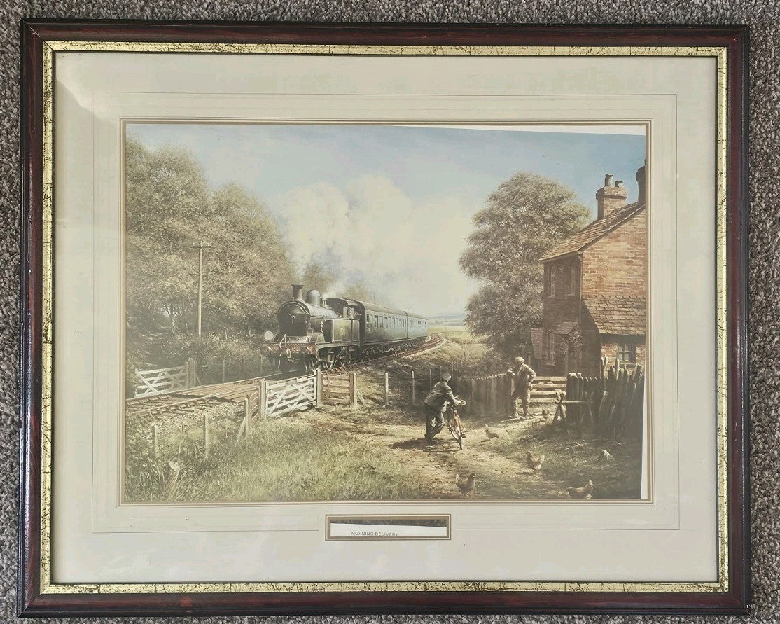 A Vintage Framed Print of a Train and Village Titled - Morning Delivery