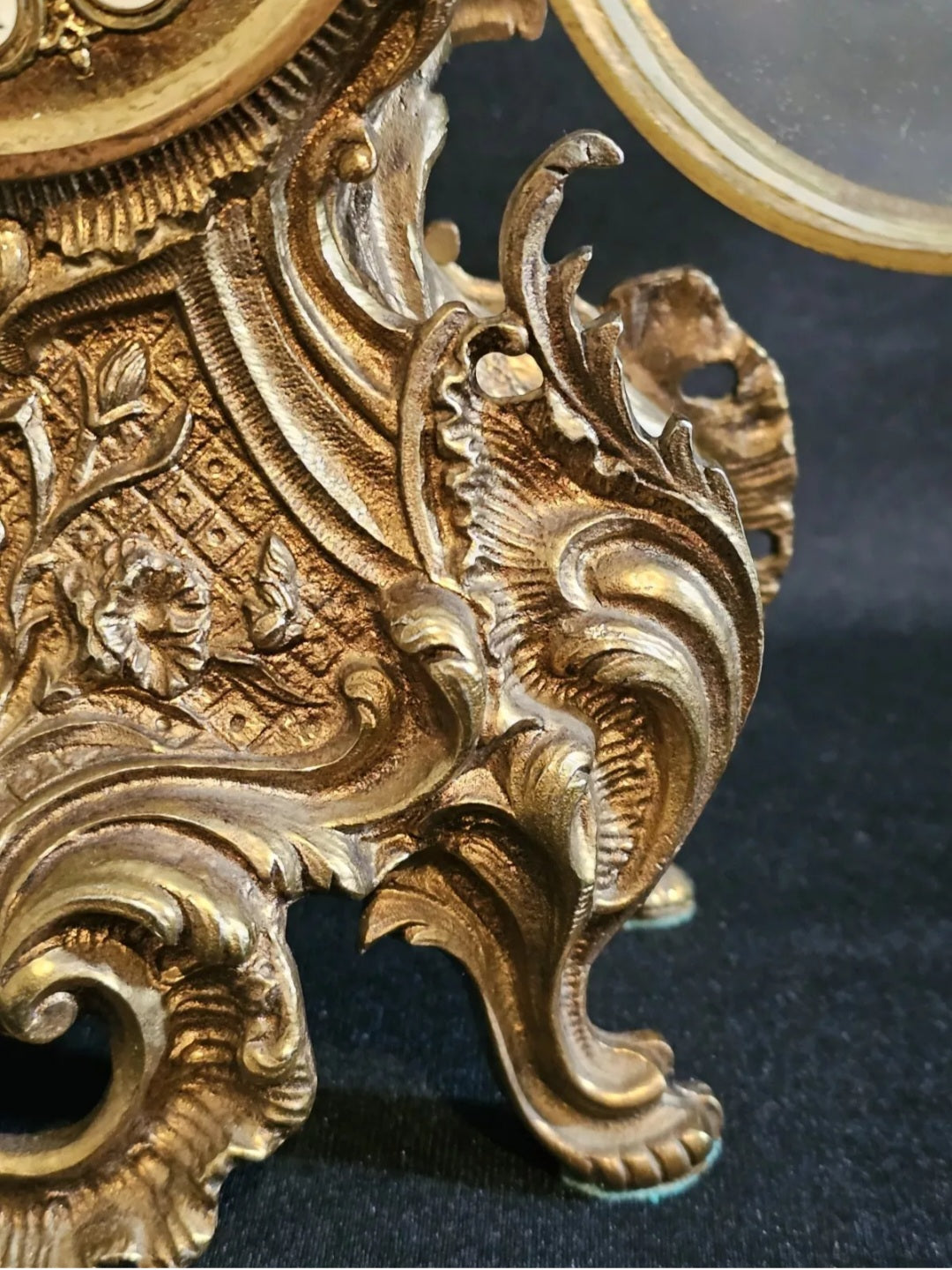 A Louis XV Style Brass Mantle Clock, Mounted with a Cherub, the Dial with Enamel