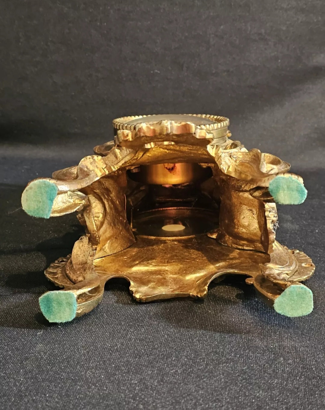 A Louis XV Style Brass Mantle Clock, Mounted with a Cherub, the Dial with Enamel